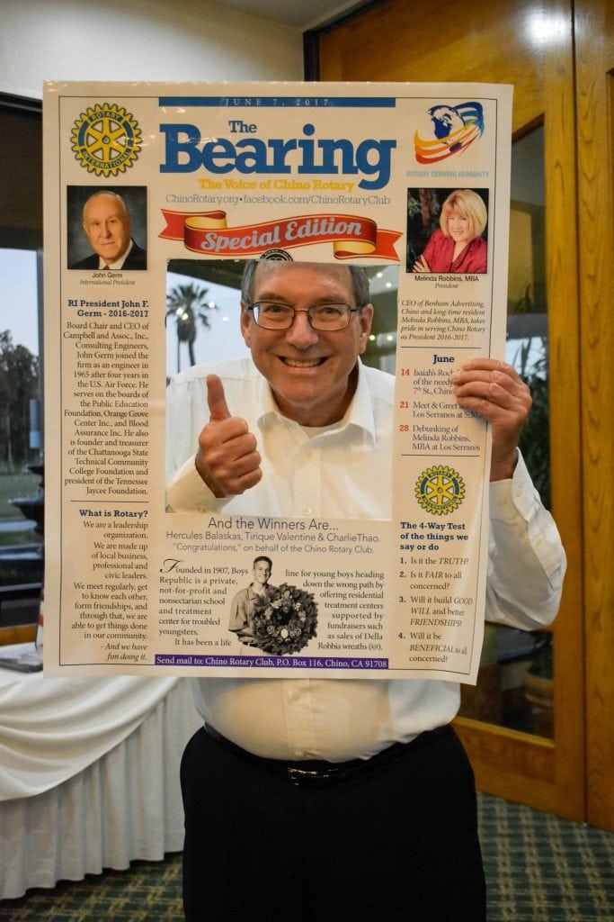 Jeff Werner Poses with a Rotary Newsletter Prop